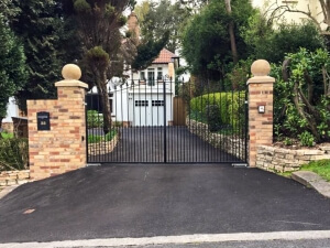 automated steel swinging bell top metal driveway gates with finials and dog bars bristol