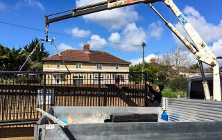 installation of steel swinging straight top metal gates with finials